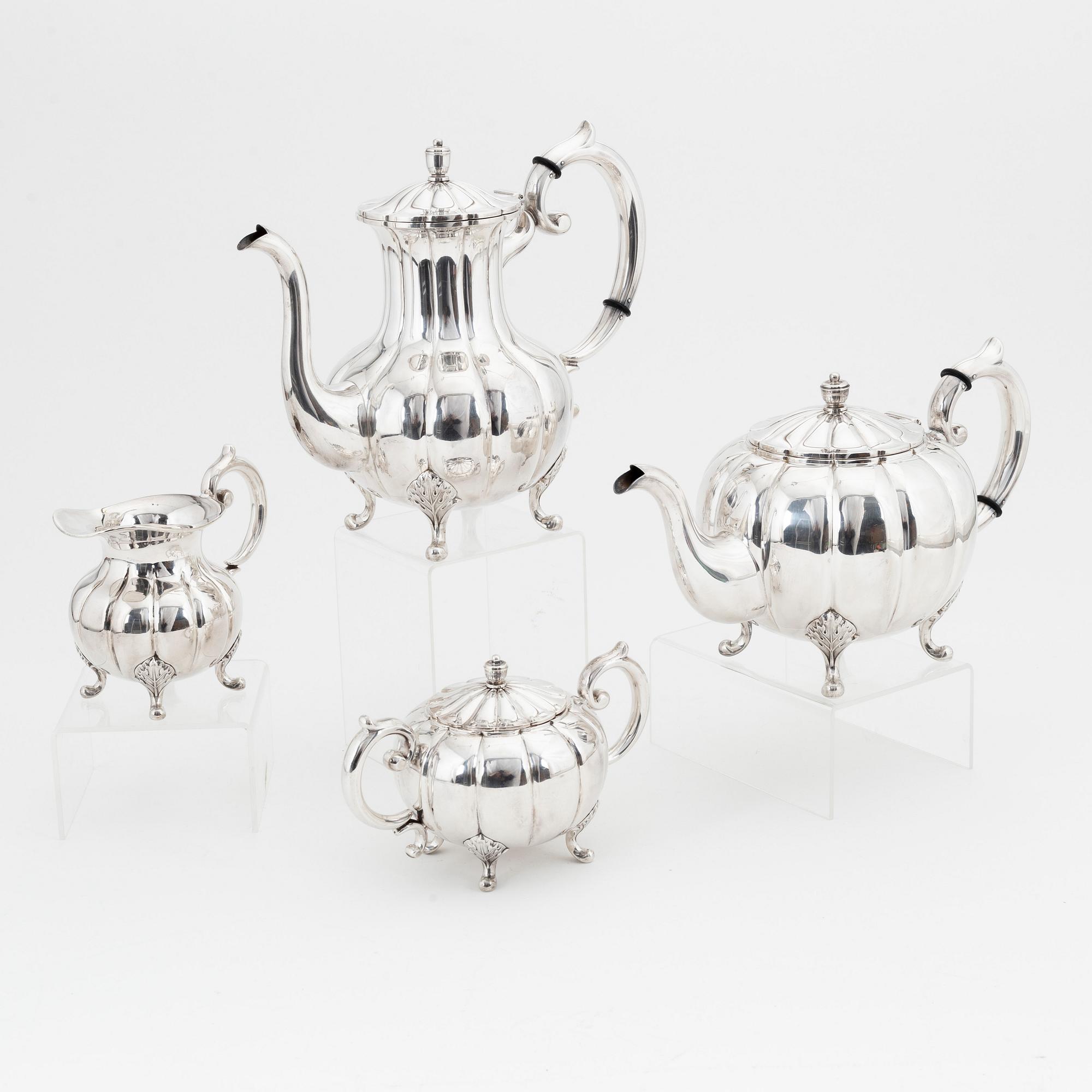 A rococo style sterling silver teapot, coffee pot, creamer and sugar bowl.