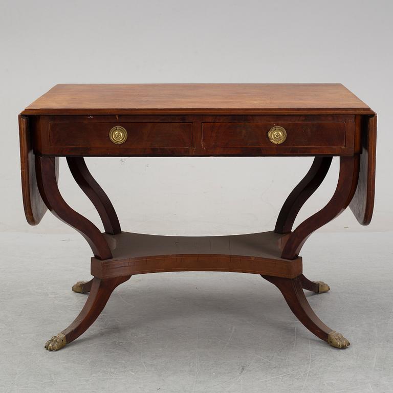 An Empire style mahogany  center table from around the year 1900.