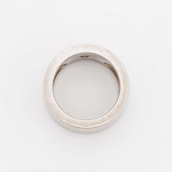 A Cartier 18K white gold ring set with a round brilliant-cut diamond.