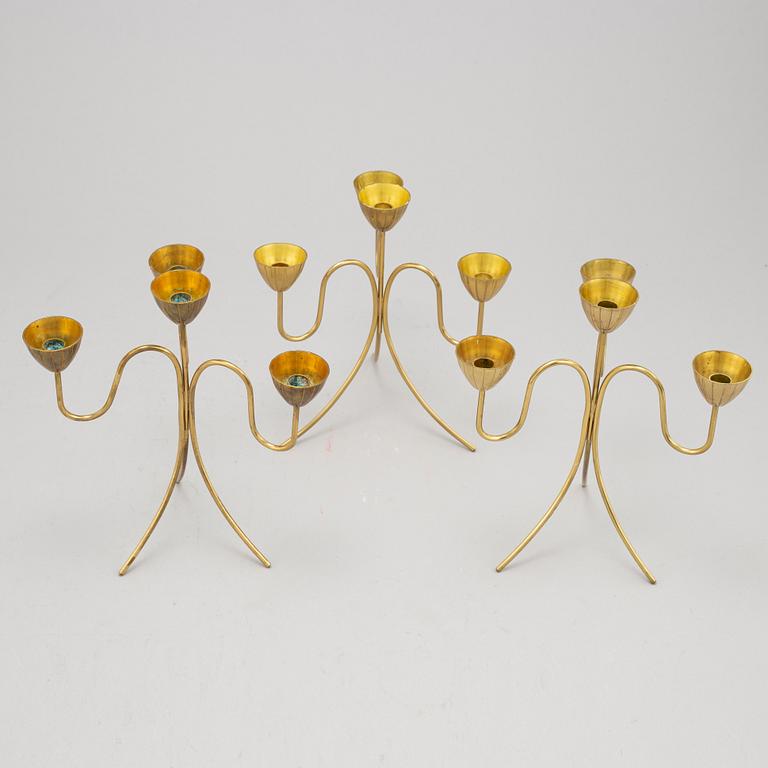 Gunnar Ander, a set of three brass five-light candelabra from Ystad Metall.