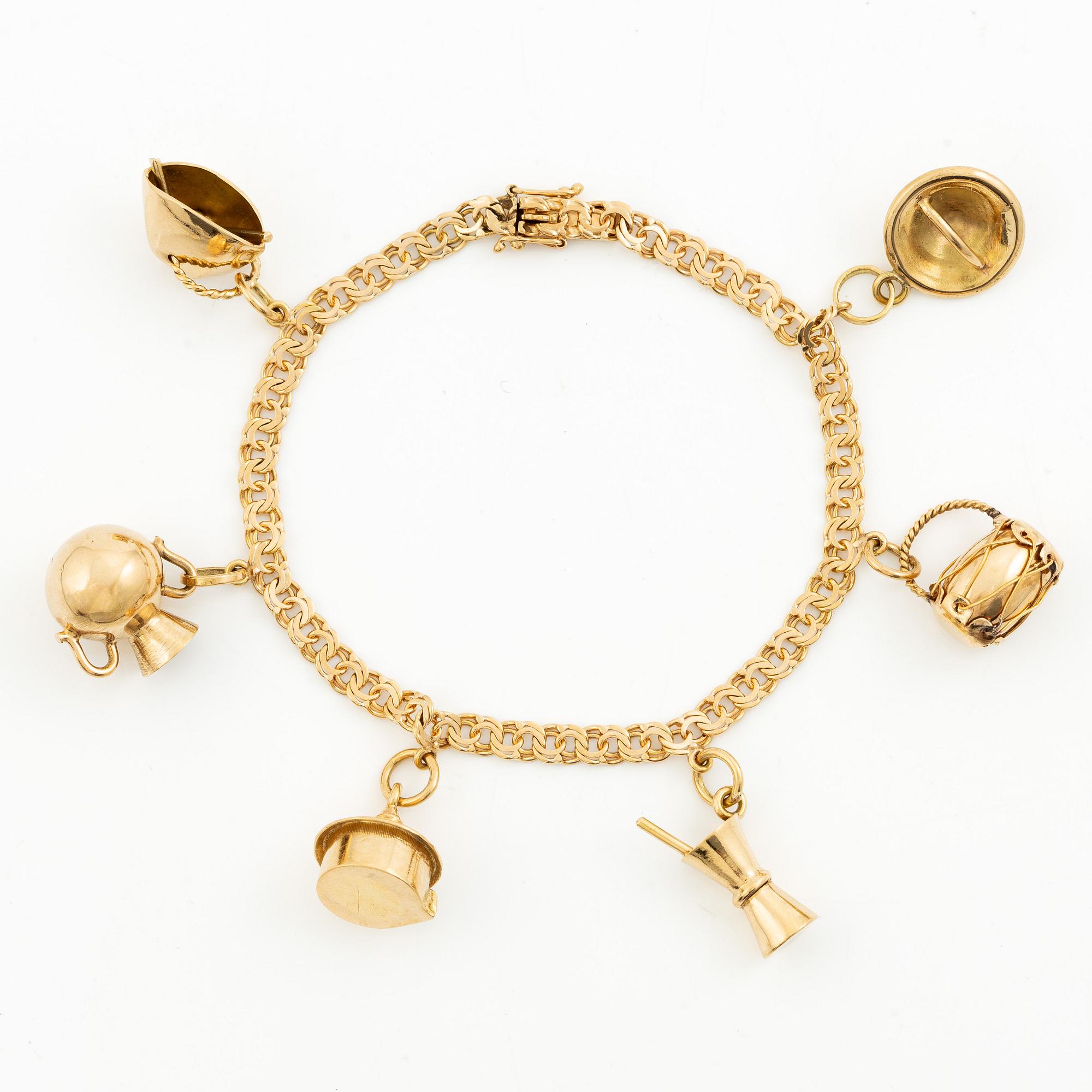 Bracelet, 18K gold bismarck link. With charms.