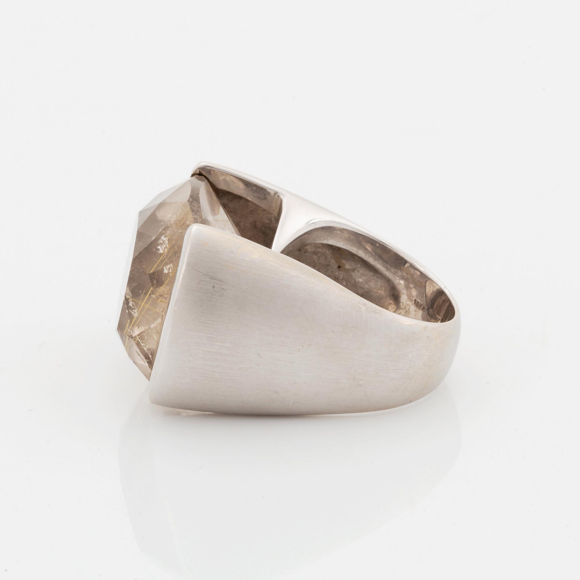 A Tina Karlsson ring in 18K white gold ring set with a faceted rutile quartz.