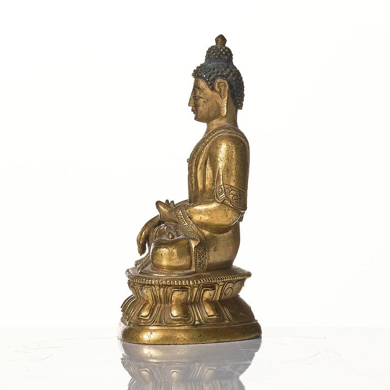 A gilt bronze figure of Shakyamuni buddha, Tibeto-Chinese, 18th century.