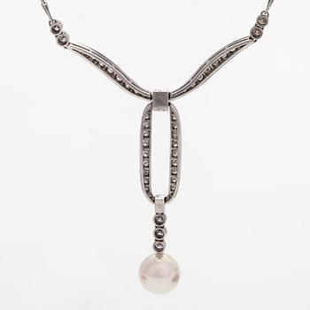 An 18K white gold necklace with brilliant-cut diamonds and a cultured pearl, England.