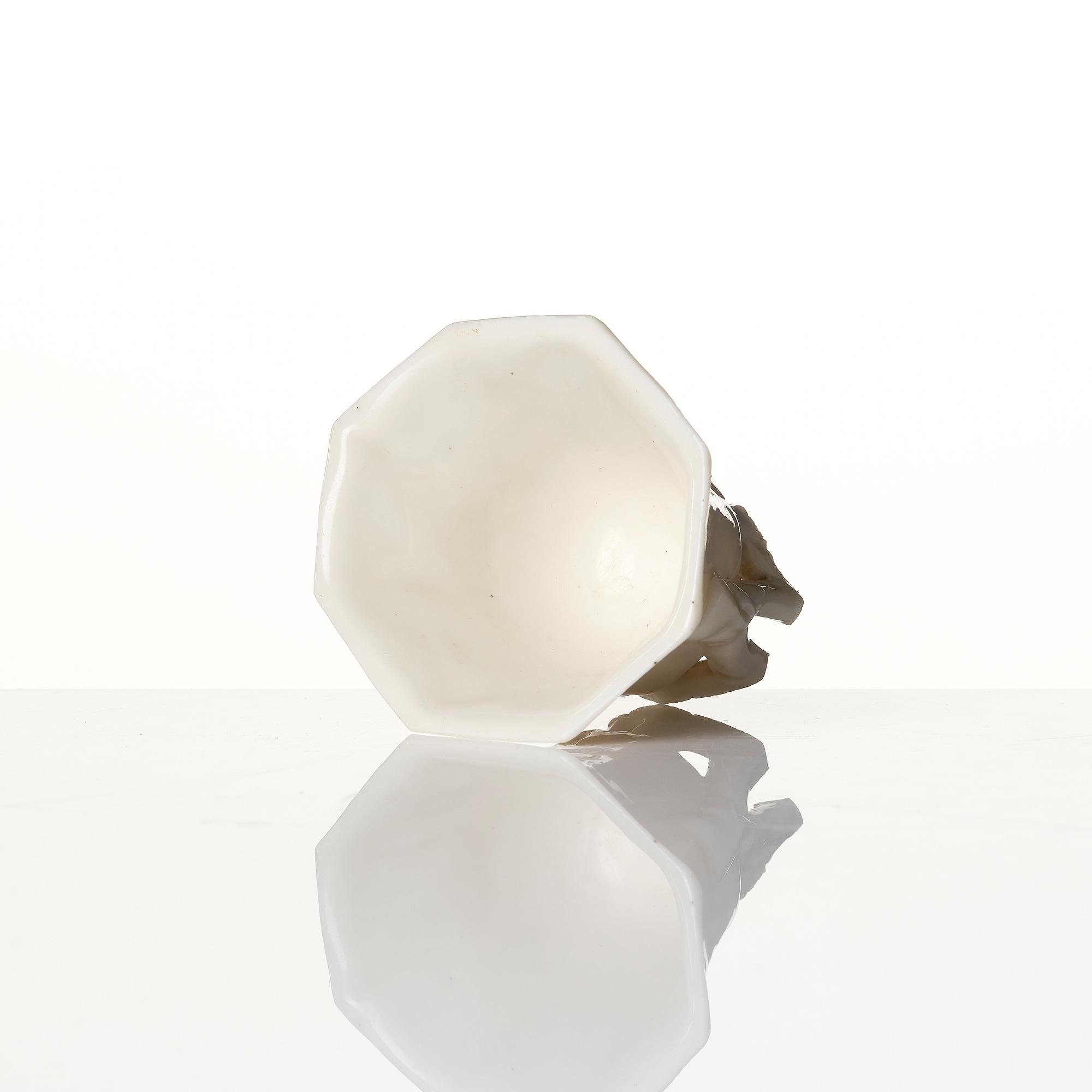 A lacquer tea box and a blanc de chine cup, Qing dynasty 18/19th century.