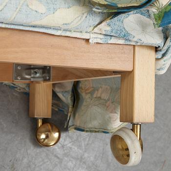 A Swedish armchair and stool, Norell Möbel, late 20th century.