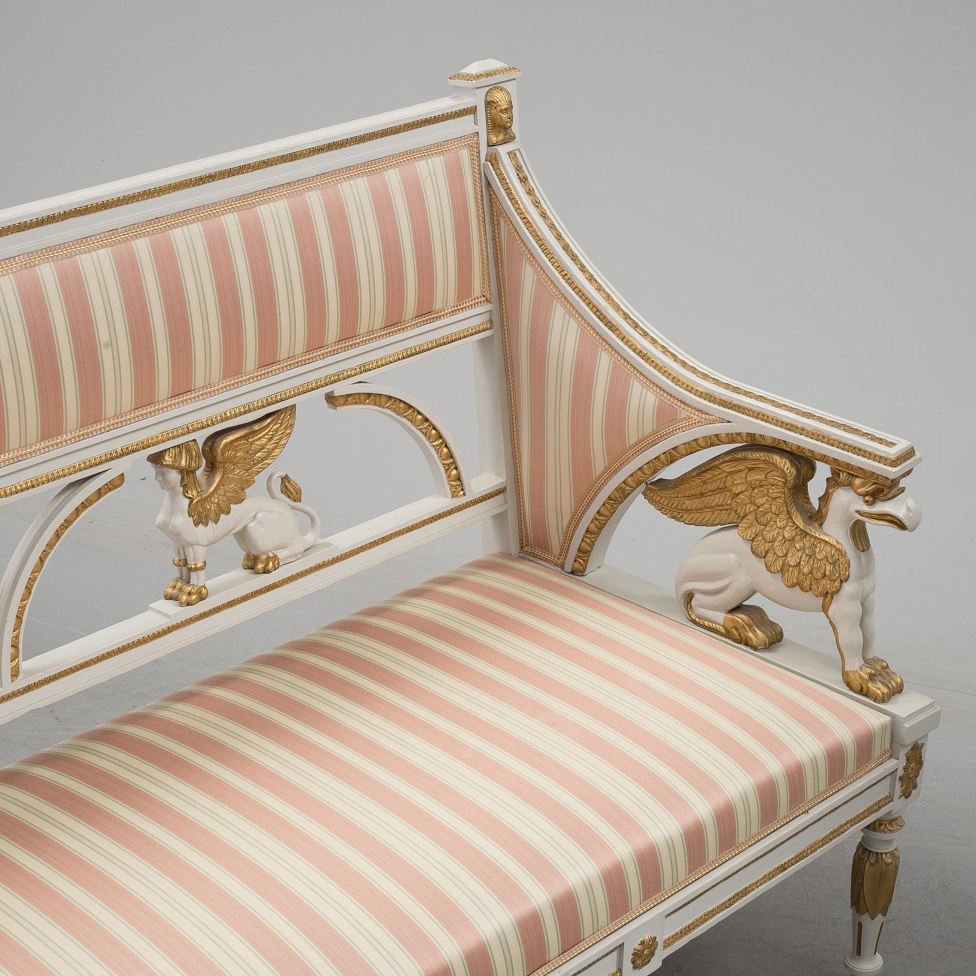 A set of two armchairs, a sofa, a stool and a chair. Early 20th century.