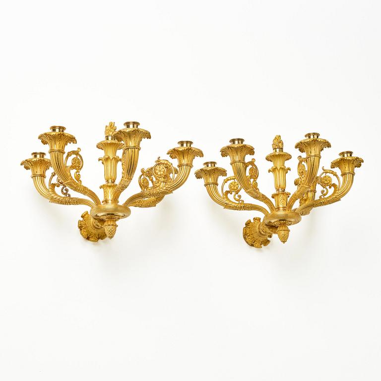 A pair of French Empire six-branch ormolu appliques, ca 1820's.