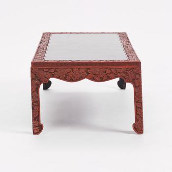 A carved lacquered table, early 20th Century.