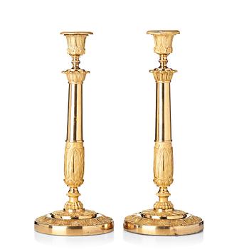 109. A pair of French Empire candlesticks, early 19th century.