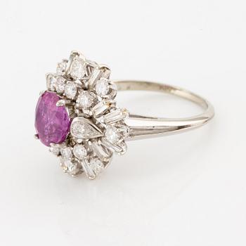 An 18K white gold ring set with a ruby and brilliant-cut and baguette-cut diamonds.