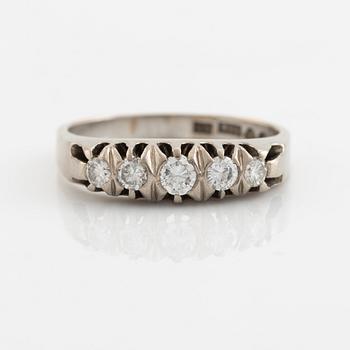 An 18K white gold ring set with round brilliant-cut diamonds.