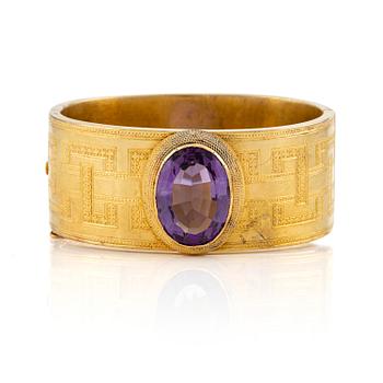 A 14K gold braclet with a faceted amethyst.