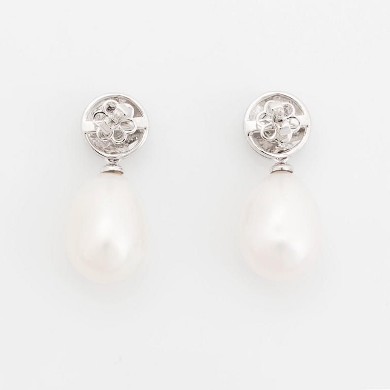 A pair of 18K white gold and cultured pearls earrings set with round brilliant-cut diamonds.