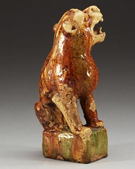 A potted figure of a 'Buddhist Lion', Tang dynasty (618-907).