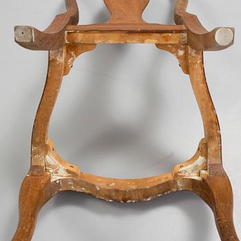 a set of eight rococo-style oak chairs from the 20th century.