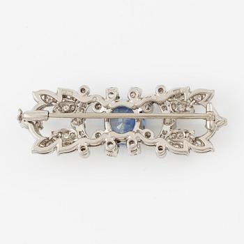 A W.A. Bolin brooch in platinum with a faceted sapphire.