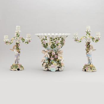 A pair of porcelain rococo style candelabra and a centerpiece bowl, Plaue, Germany, first half of the 20th century.