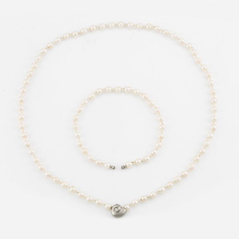 Ole Lynggard lås i form av snäcka 18K vitguld med en rund briljantslipad diamant.