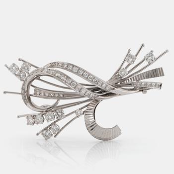 970. An 18K white gold brooch set with round brilliant- and eight-cut diamonds.