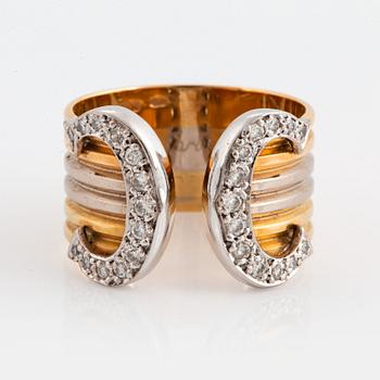 993. A Cartier "Double C" ring in 18K tri color gold set with round brilliant-cut diamonds.