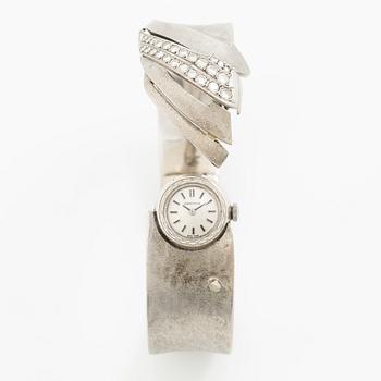 Aftonklocka/armring, Bo Dolk, 18K vitguld med briljantslipade diamanter, 1970-tal.