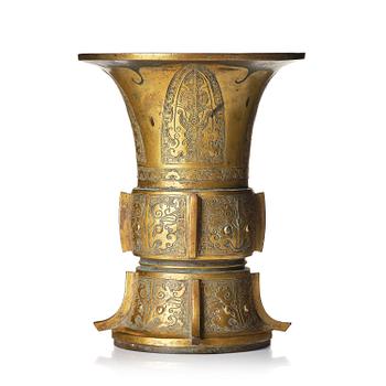 1023. A parcel gilt/gold splashed bronze vase, Gu, 17/18th century.