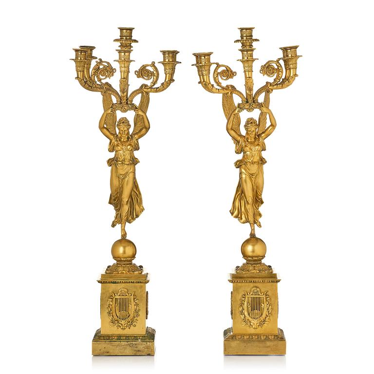 A pair of six-branch gilt bronze Empire candelabra, Paris, early 19th century.