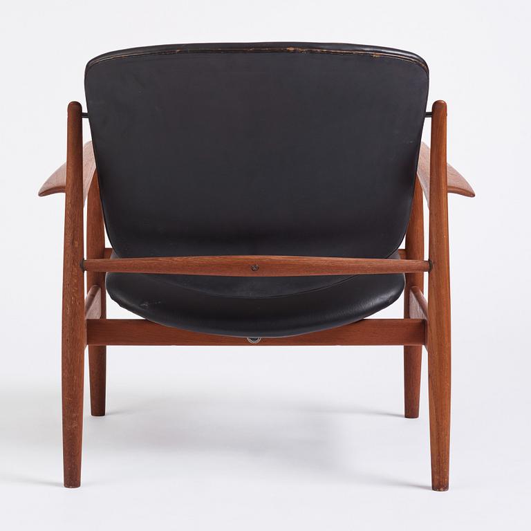 Finn Juhl, a teak and black leather 'model 136' easy chair, France & Daverkosen, Denmark 1950-60s.