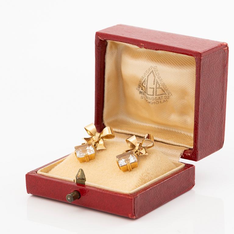 A pair of 18K gold earrings with faceted rock crystal.