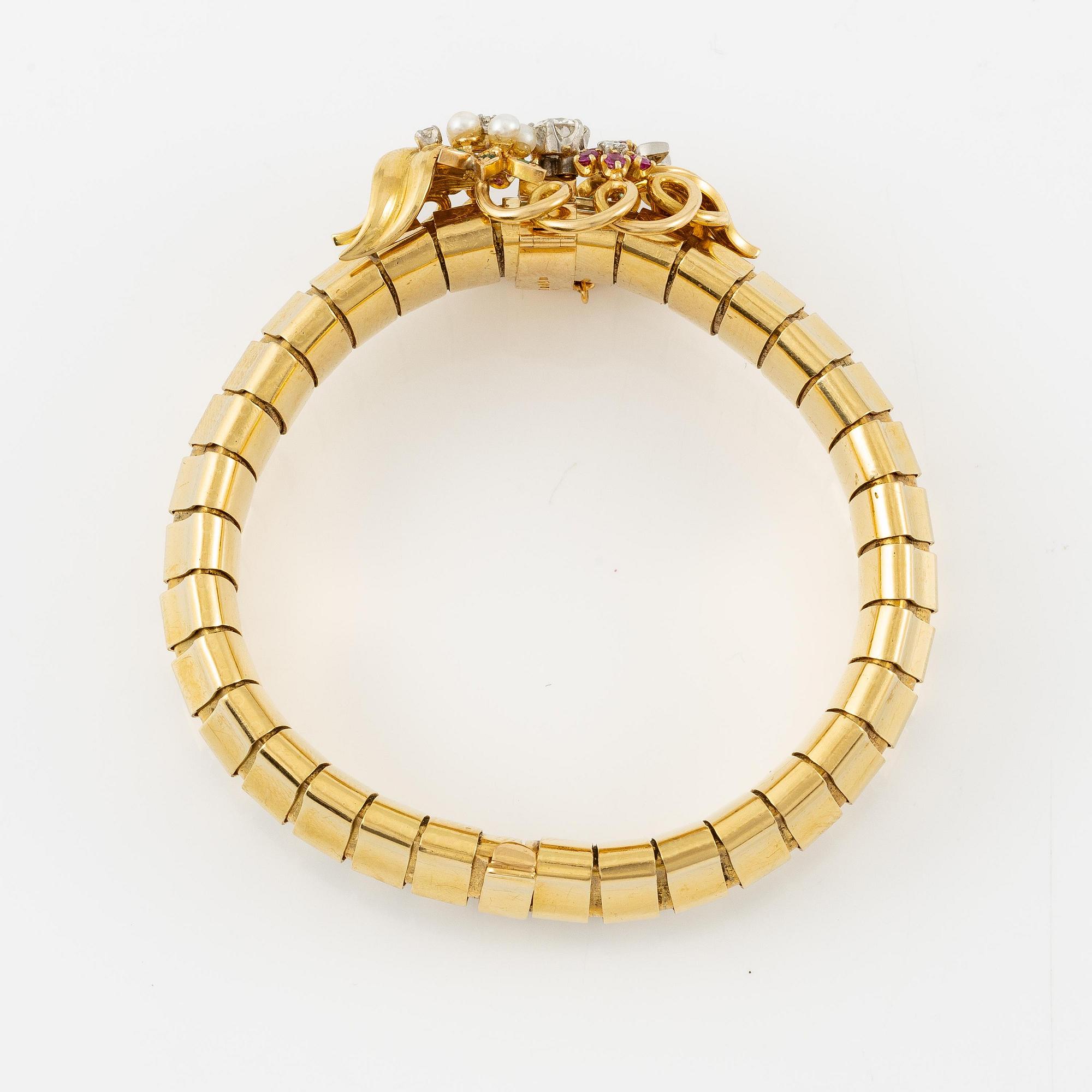 A Strömdahls bracelet/pendant combination in 18K gold with rubies, emeralds, pearls and diamonds.