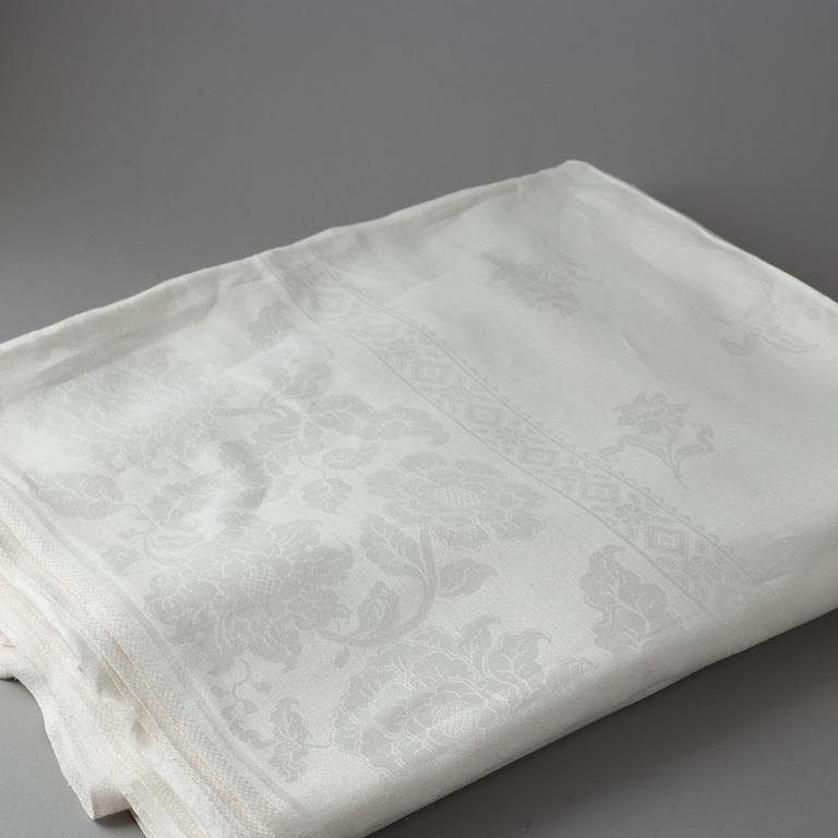 A tablecloth, linen damask, ca 680 x 212 cm. Conjugal coat of arms.