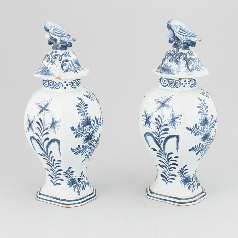 A pair of 19th century blue/white faience lidded jars, probably Dutch.