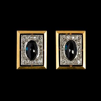1037. CUFFLINKS, blue cabochon cut sapphires set with small diamonds. St Petersburg, early 20th century.