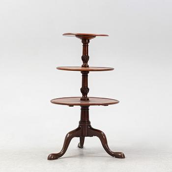 A mahogany three-tier table, England, circa 1900.