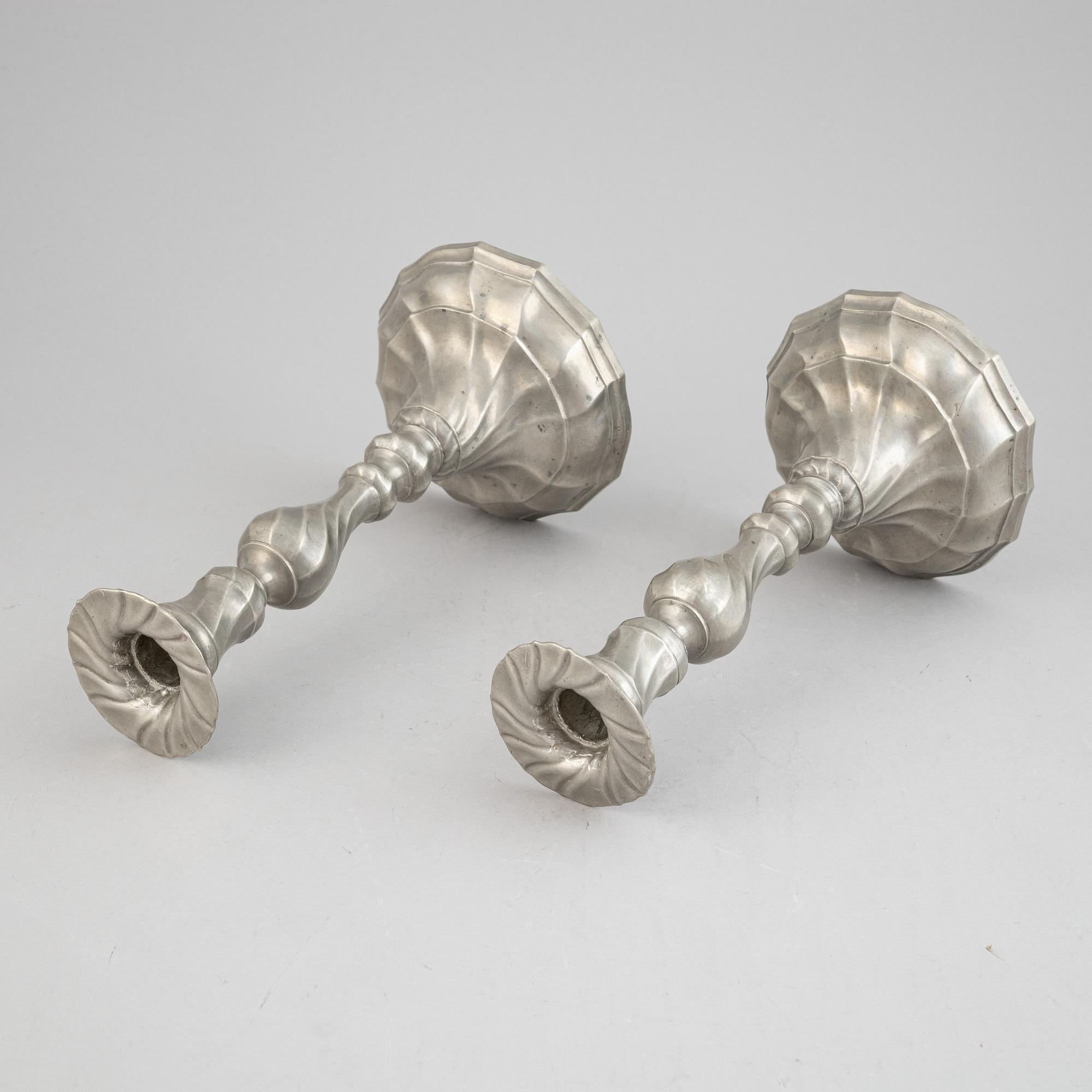 A pair of rococo style pewter candlesticks, 19th Century.