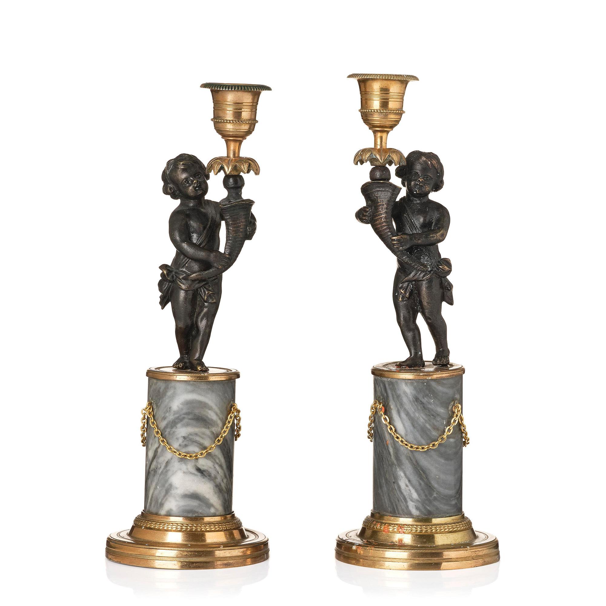 A pair of French Louis XVI ormolu and marble candlesticks, late 18th century.