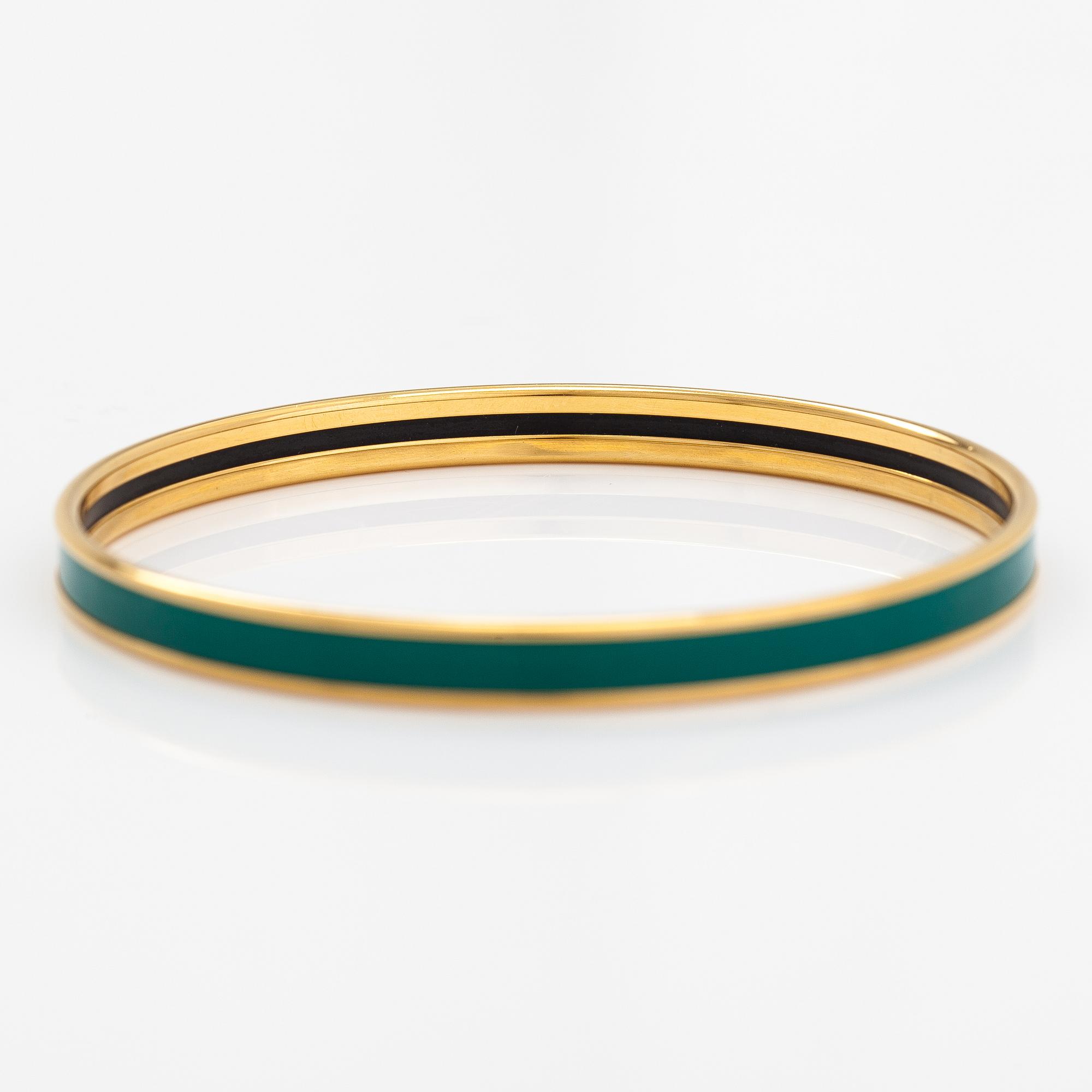 Hermès, a bracelet made of gold coloured metal and green enamel. Marked Hermès Paris, Made in France.