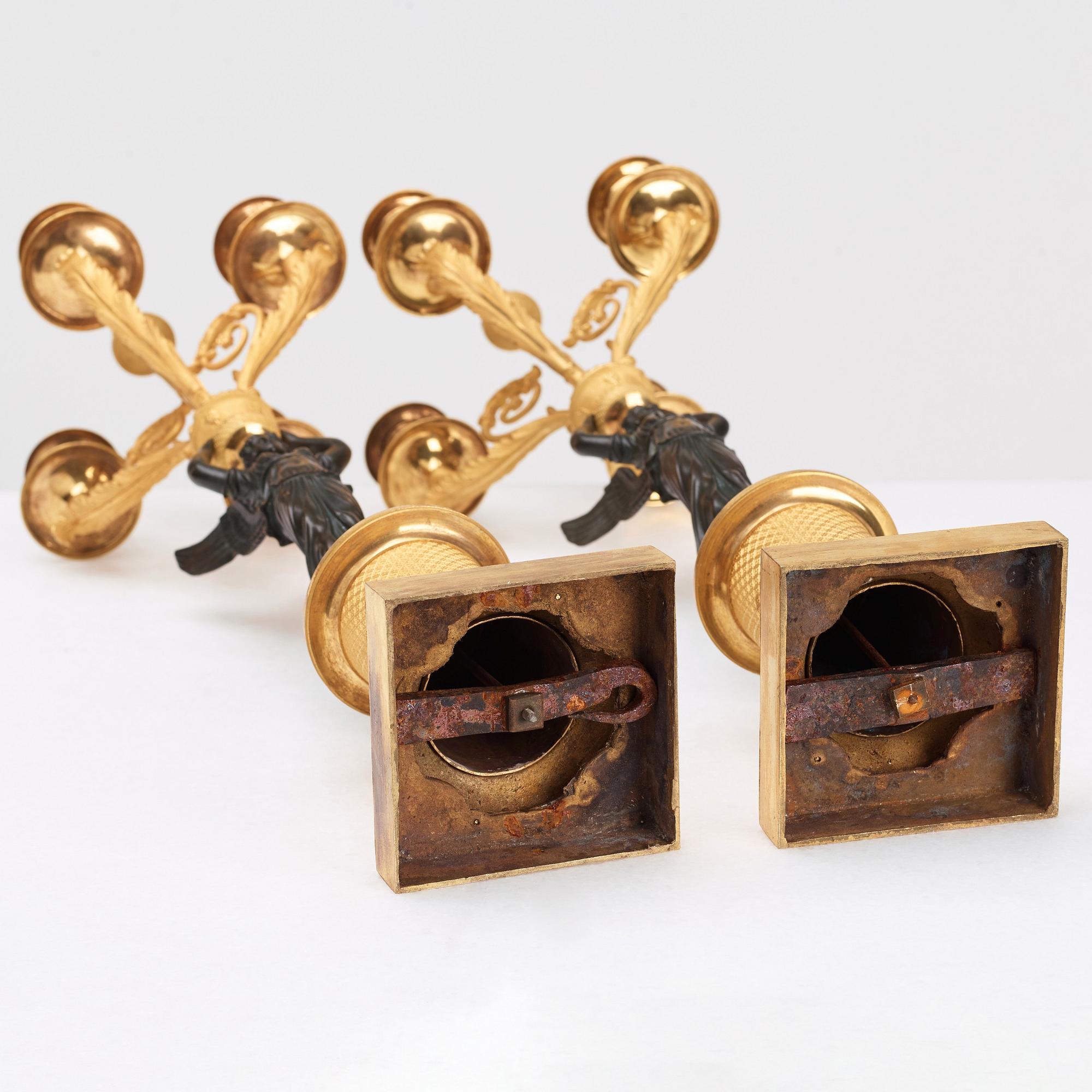 A pair of Empire four light candelabra.