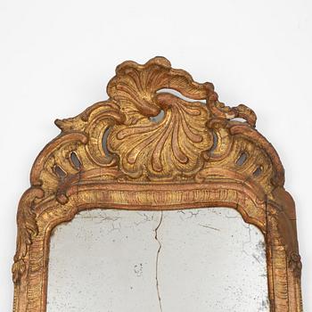 A Swedish rococo giltwood mirror in the manner of E. Göbel, Stockholm, later part 18th century.