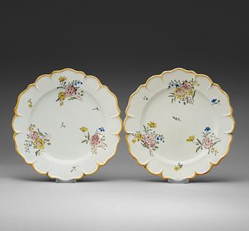 A pair of Swedish faience chargers, Rörstrand, dated 3/8 (17)64.