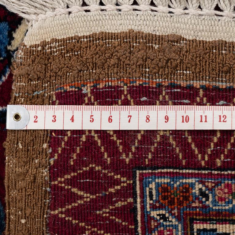 A Mashad carpet, signed Saber, c. 402 x 299 cm.