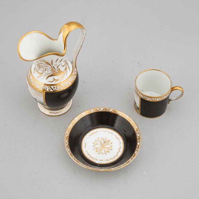 A porcelain jug and a cup with saucer, empire style, circa 1900.