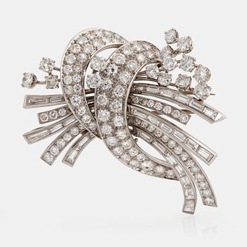 998. A platinum and 18K gold brooch set with round brilliant- and baguette-cut diamonds.