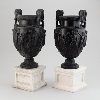 A pair of basalt ware volute vases, 19th century.