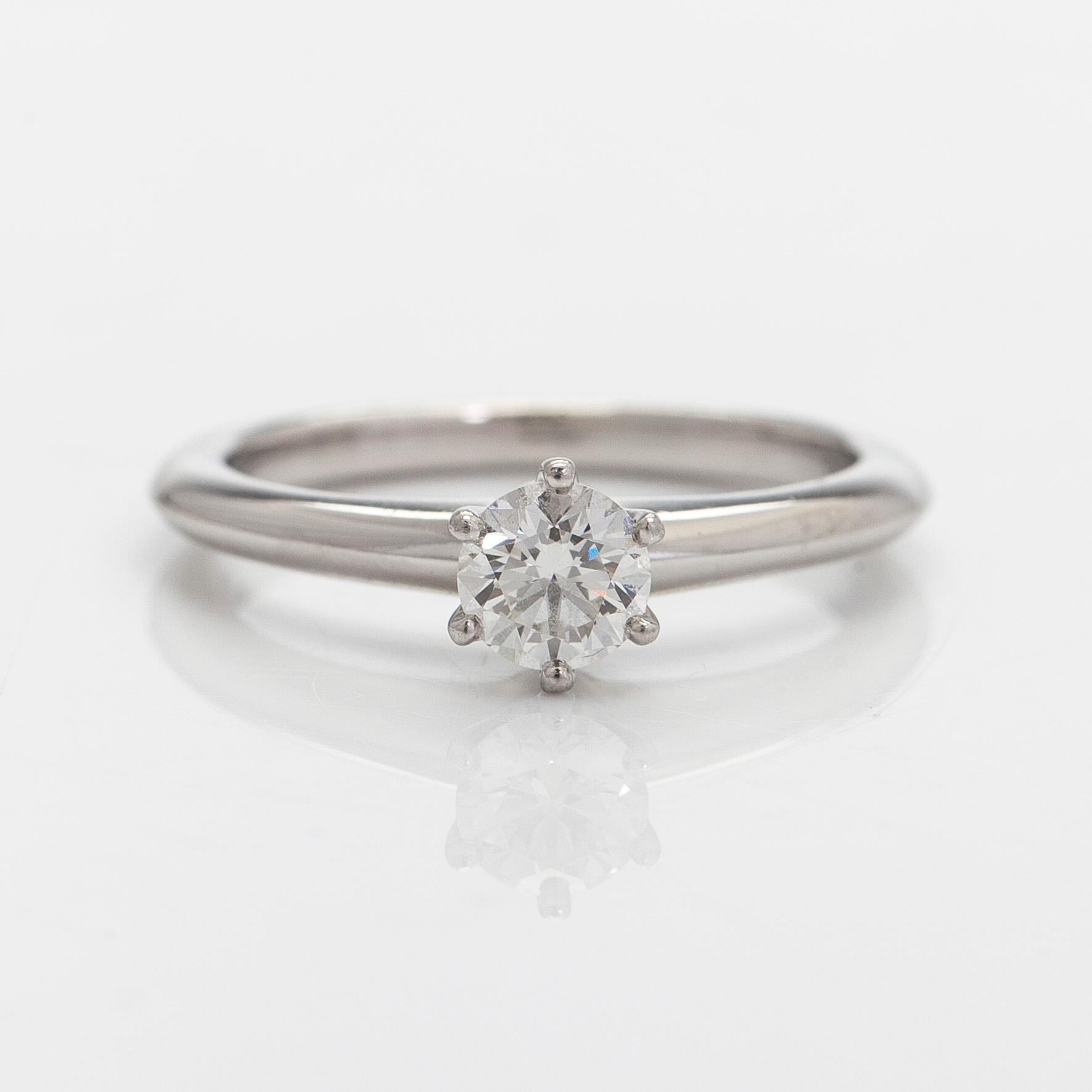 Tiffany & Co, a platinum solitaire ring with a brilliant-cut diamond.