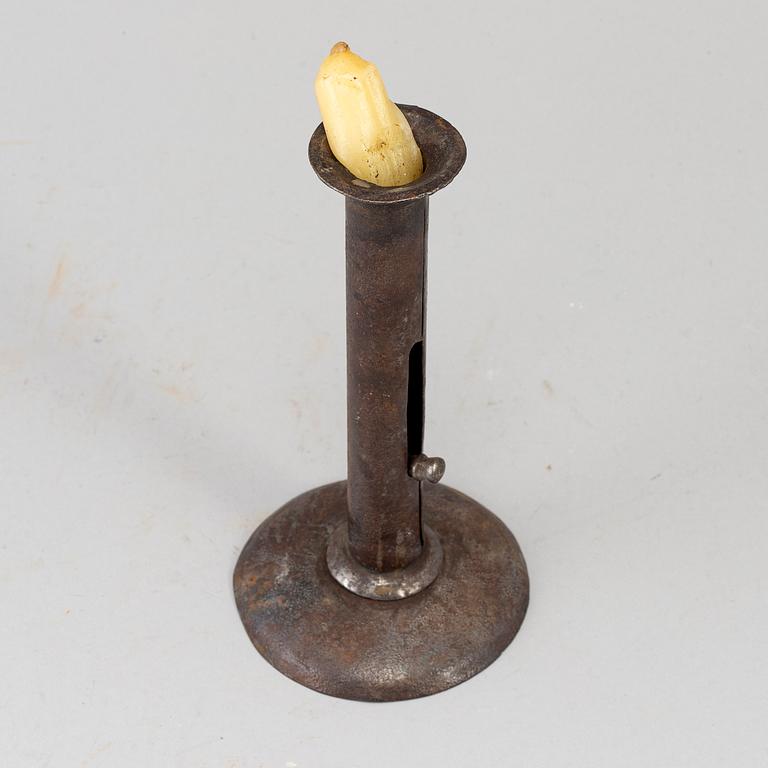 An 18th century tinplate candlestick.