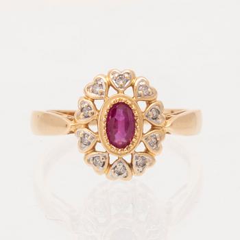 An 18K gold ring set with an oval brilliant cut ruby and round brilliant cut diamonds.
