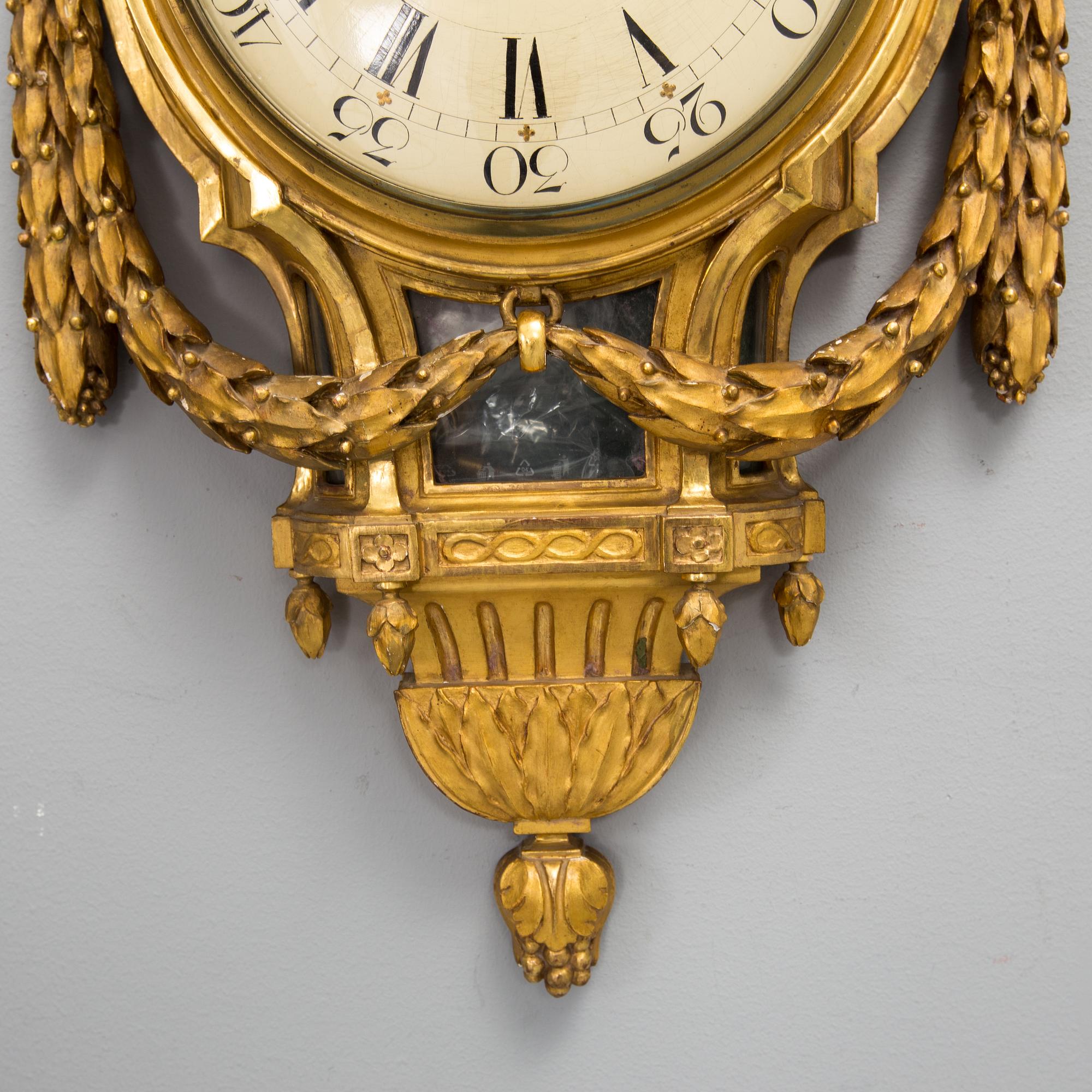 A wall clock in gustavian style, marked Rob. Engström, Stockholm.