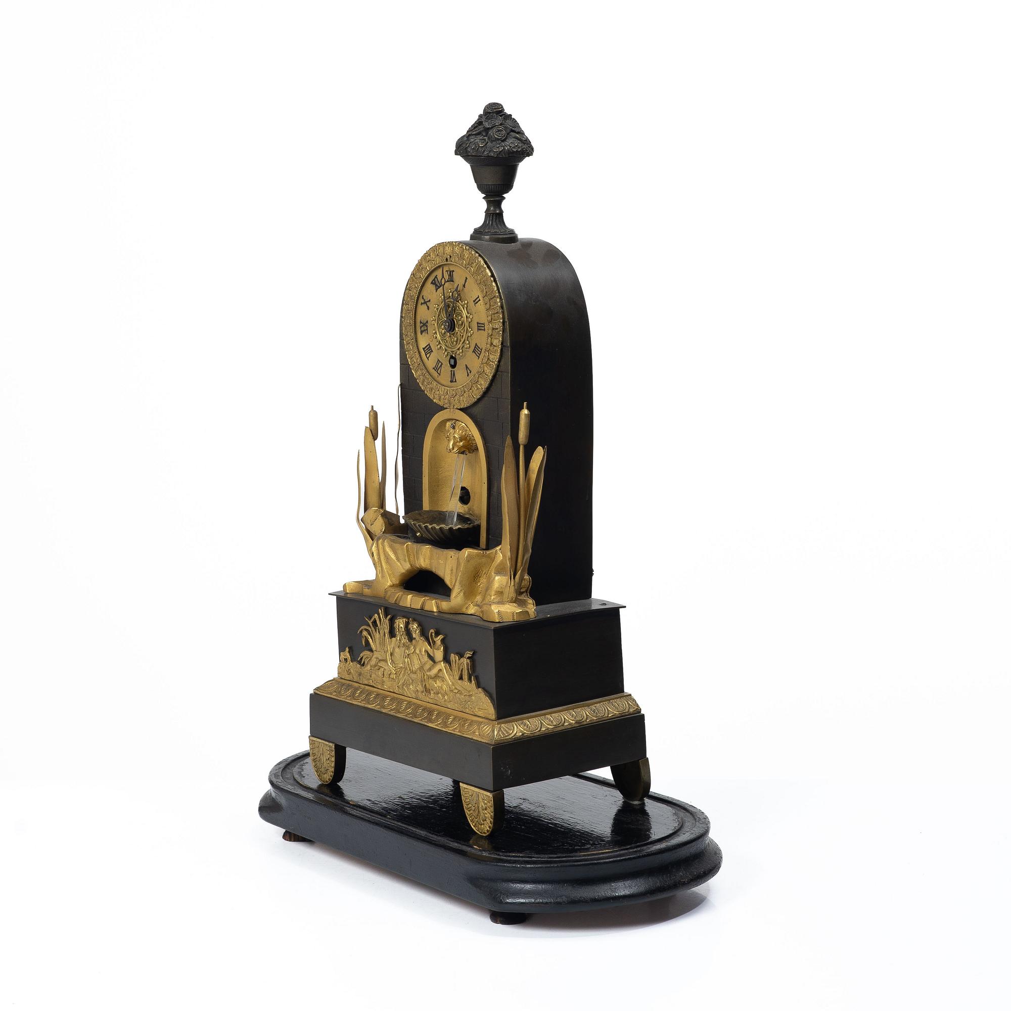 A French Charles X ormolu and patinated bronze mantel clock, ca 1820's.